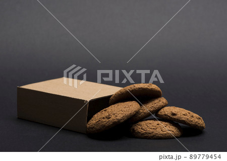 Cookies in carton box on dark grey background. 89779454