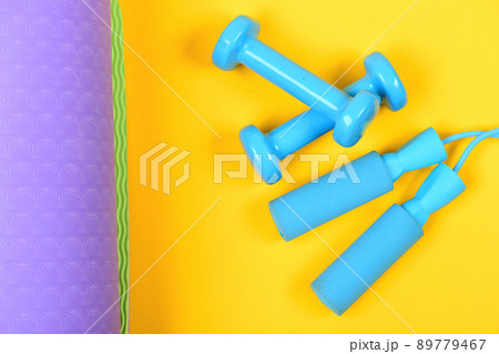 Dumbbells and jump rope in cyan blue color Dumbbells and jump rope in cyan blue color 89779467