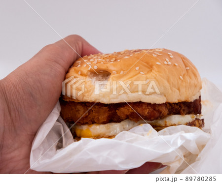 Closeup of big beef hamburger in food wrapping foil Closeup of big beef hamburger in food wrapping foil 89780285