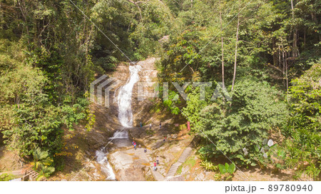 Waterfall in cameron highlands, malaysia. The water tumbles down the rocks into a small river. Refreshment for trekkers through the jungles of Malaysia. Rainforest creek between the dense jungle 89780940