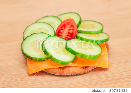 Crispy Cracker Sandwich with Fresh Cucumber, Tomato Cherry and Cheese Crispy Cracker Sandwich with Fresh Cucumber, Tomato Cherry and Cheese 89781438