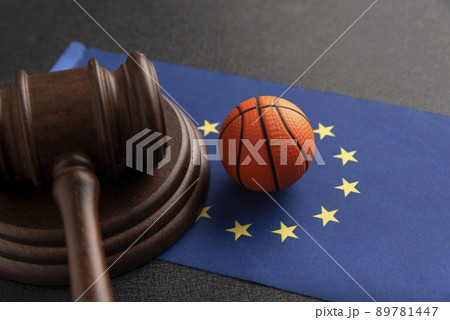Basket ball and Judge gavel on the flag of European Union. . Basketball betting in EU. Sport betting concept Basket ball and Judge gavel on the flag of European Union. . Basketball betting in EU. Sport betting concept 89781447