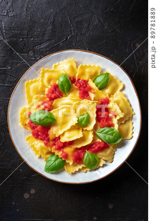 Ravioli with tomato sauce and basil. A plate of stuffed pasta, shot from above Ravioli with tomato sauce and basil. A plate of stuffed pasta, shot from above 89781889
