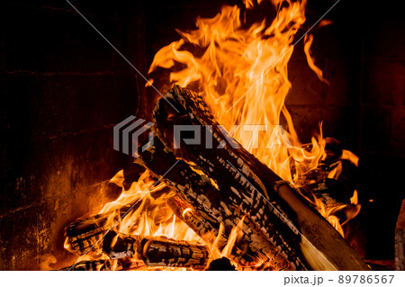 Indoors fireplace on home with smoldering wooden log Indoors fireplace on home with smoldering wooden log 89786567