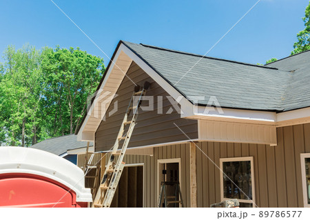 Roof shingles in top the on new home under construction site 89786577