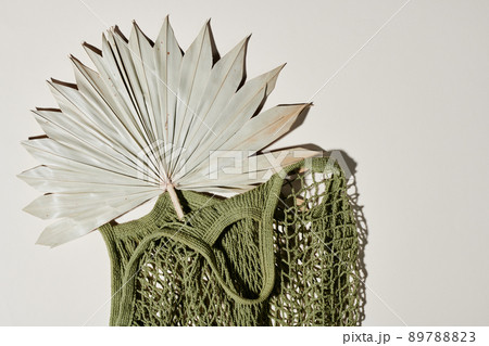 Top view of handmade knitted handbag of green color with fan inside 89788823