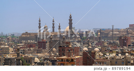 Aerial view of old Cairo, Egypt with grunge buildings and Sultan Hasan Mosque in far distance Aerial view of old Cairo, Egypt with grunge buildings and Sultan Hasan Mosque in far distance 89789194