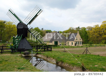 typical dutch village with a windmill near amsterdam typical dutch village with a windmill near amsterdam 89789442