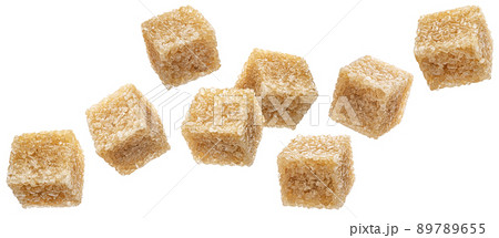 Falling cubes of cane sugar isolated on white background Falling cubes of cane sugar isolated on white background 89789655