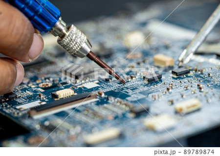 Technician repairing inside of mobile phone by soldering iron. Integrated Circuit. the concept of data, hardware, technology. 89789874