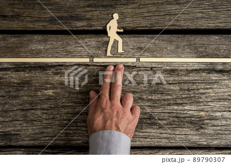 Business teamwork concept with the hand of a businessman supporting paper cut out of a man 89790307