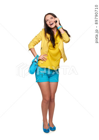 Young woman in full length talking on cellphone, over white background 89790710