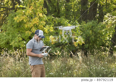 Man manages quadrocopters. Remote control for the drone in the hands of men. Unmanned aerial vehicle Man manages quadrocopters. Remote control for the drone in the hands of men. Unmanned aerial vehicle 89792119