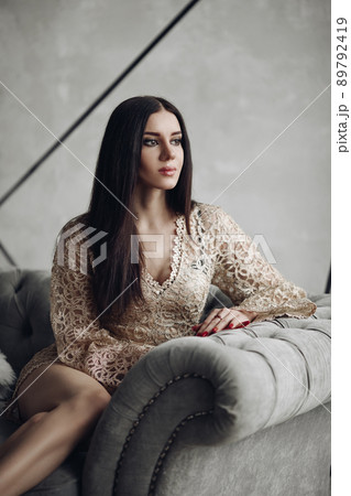 Alluring model in beige laced romper and high 89792419
