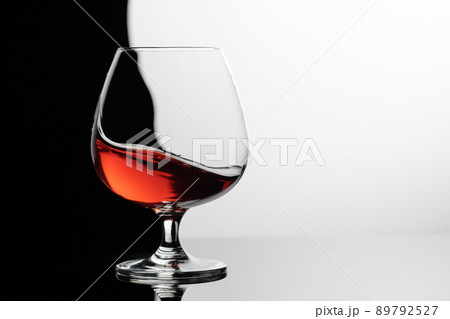 Splash of brandy in a snifter glass. 89792527