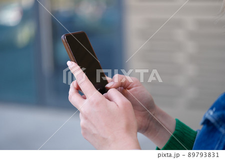 Woman surfing internet on smartphone or typing message Woman surfing internet on smartphone or typing message 89793831