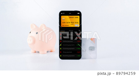 E banking concept. Mobile phone with internet online bank app. Pig bank with credit card on white background. Online wallet save money. E banking concept. Mobile phone with internet online bank app. Pig bank with credit card on white background. Online wallet save money. 89794259