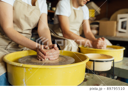Hands of a potter. Potter making ceramic pot on the pottery wheel 89795510