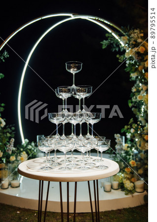 Champagne glasses standing in a tower at the party 89795514