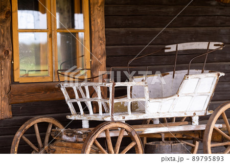 An empty antique carriage stands on a ranch in the wild West An empty antique carriage stands on a ranch in the wild West 89795893