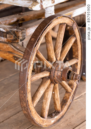 old wooden wheels are on the carriage at the ranch 89795900