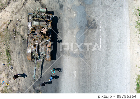 Kyiv region, Ukraine - May 15, 2022: War in Ukraine. Highway Kyiv - Zhytomyr. People take selfies against destroyed russian tank after russian atack in Febrary. 89796364