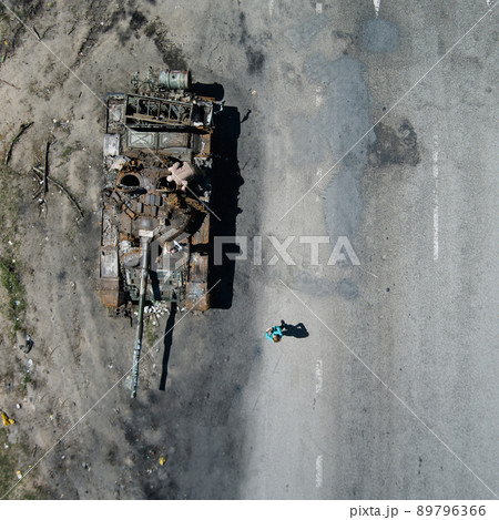 Kyiv region, Ukraine - May 15, 2022: War in Ukraine. Highway Kyiv - Zhytomyr. People take selfies against destroyed russian tank after russian atack in Febrary. 89796366