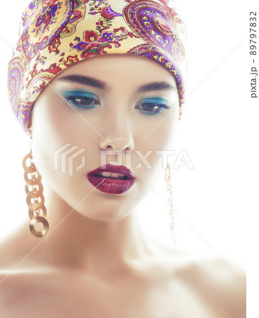 young pretty modern girl with bright shawl on head emotional posing isolated on white background, asian people ethnicity close up 89797832