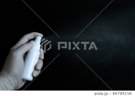 Alcohol bottle for hygiene in hand with isolated on black background Alcohol bottle for hygiene in hand with isolated on black background 89799156