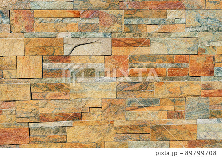 texture of a stone wall. Earth coloured slate stone background. Stone texture wall cladding for house wall. 89799708