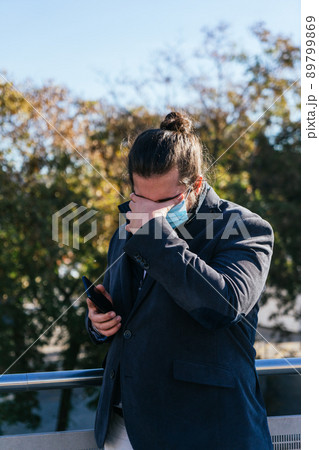 young business man gets bad news with face mask 89799869