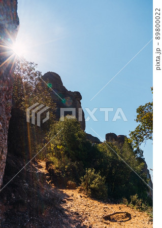 Mountain scenery, forest illuminated by the sunbems and blue sky. Mountain of Montserrat Spain. Mediterranean sight Mountain scenery, forest illuminated by the sunbems and blue sky. Mountain of Montserrat Spain. Mediterranean sight 89800022