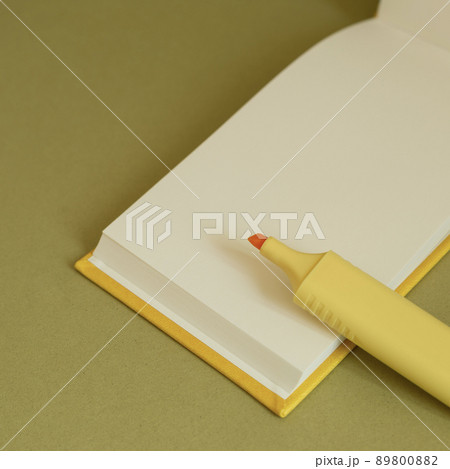 Open blank notebook and yellow highlighter on desk Open blank notebook and yellow highlighter on desk 89800882