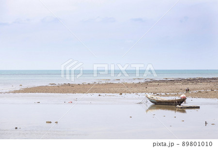 individaul fisherman boat landscape on ocean beach 89801010