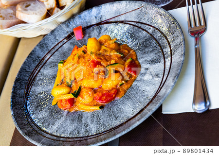 Tasty dumplings from salmon and stewed zucchini and tomatoes 89801434