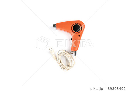 Vintage orange hair dryer on white background with rolled cable buttom. 89803492