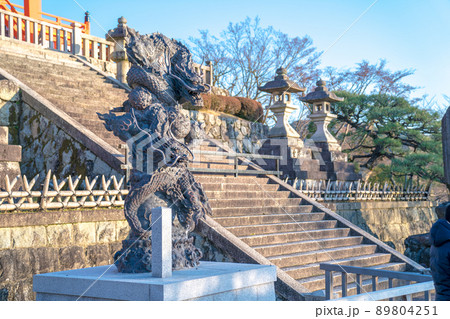 Two rock Asia dragons statue with yellow eye rolling the pole posture 89804251