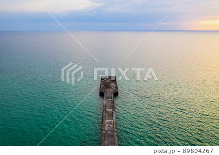 The jetty in the sea with the horizontal sea line by minimal drone photo shooting style in twilight time. Thailand. The jetty in the sea with the horizontal sea line by minimal drone photo shooting style in twilight time. Thailand. 89804267