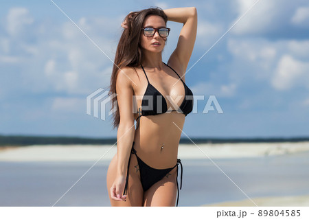 Beautiful woman in swimsuit on beach 89804585