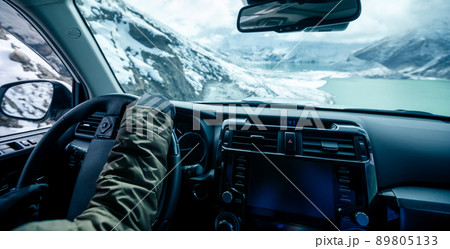 Driving off road car on snowing high altitude mountain trail on winter day . Driving off road car on snowing high altitude mountain trail on winter day . 89805133