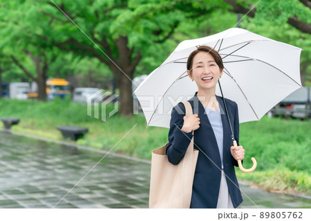 傘をさす女性　雨　梅雨　新緑 89805762