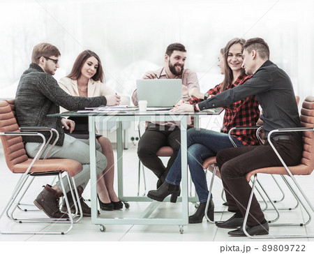 business team discussing work documents sitting behind a Desk business team discussing work documents sitting behind a Desk 89809722