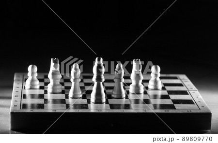 Composition with chessmen in the glossy chessboard 89809770