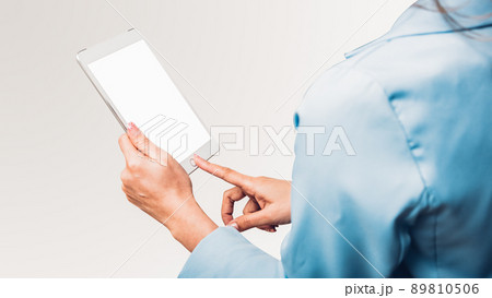 Young business woman using her touch on screen display computer tablet technology 89810506