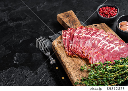 Sliced Turkish bacon Pastrami, roasted beef meat. Black background. Top view. Copy space 89812823
