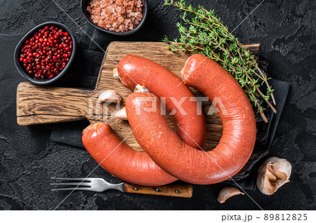 Sucuk meat sausage, Sujuk dry spicy sausage. Black background. Top view 89812825