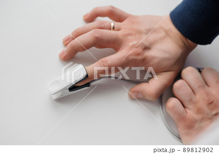 Pulse oximeter on a white background. Medical monitoring and diagnostic device for non-invasive measurement of capillary blood oxygen saturation 89812902