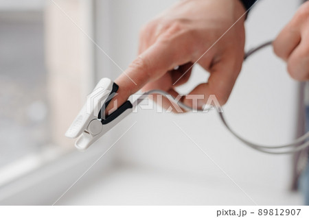 Pulse oximeter on a white background. Medical monitoring and diagnostic device for non-invasive measurement of capillary blood oxygen saturation 89812907