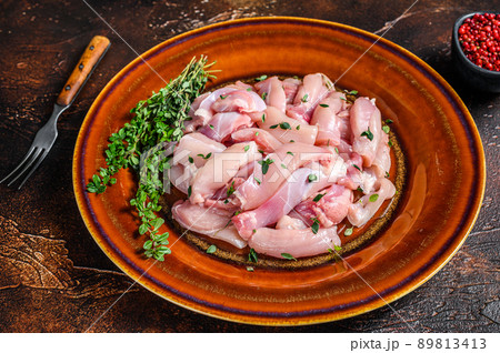 Cut Raw Chicken breast fillet on a plate. Dark background. Top view Cut Raw Chicken breast fillet on a plate. Dark background. Top view 89813413