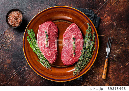 Raw Shoulder Top Blade cut, or Australia wagyu oyster blade beef steak. Dark background. Top View Raw Shoulder Top Blade cut, or Australia wagyu oyster blade beef steak. Dark background. Top View 89813448